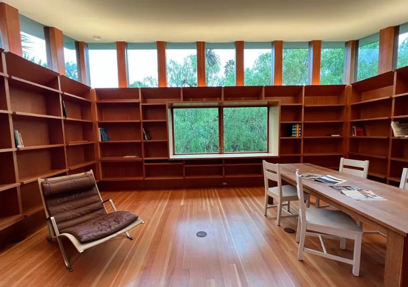 Curved timber library with furniture set in place